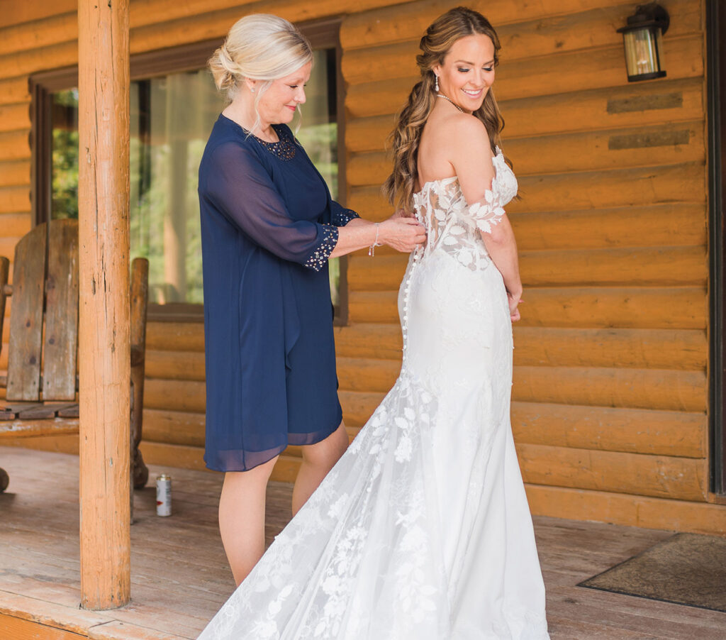 A mother helps her daughter get ready for her wedding