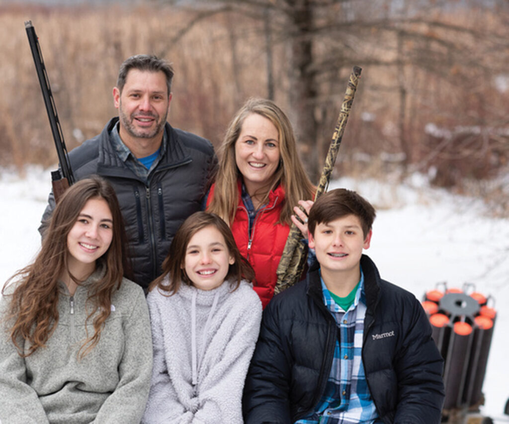 A family gearing up to shoot clay pigeons in the winter time