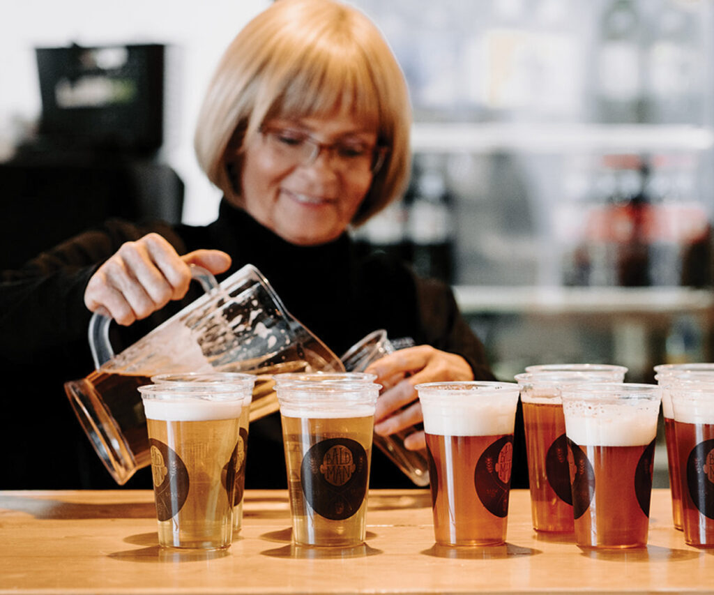 A woman pouring beers