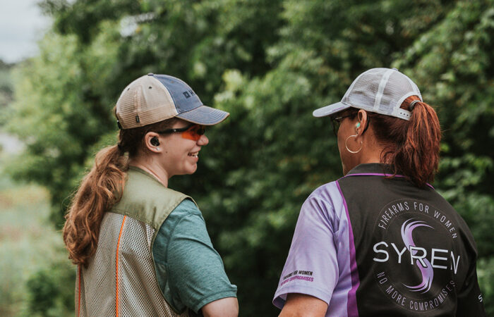 Two women shooting clays in the forest