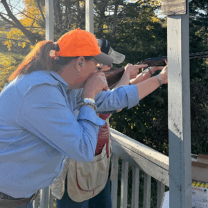 Women instructing another women on shotgun shooting